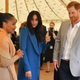 Meghan, Duchess of Sussex (C) arrives with her mother Doria Ragland (L) and Prince Harry, Duke of Sussex to host an event to mark the launch of a cookbook with recipes from a group of women affected by the Grenfell Tower fire on Sept. 20, 2018 in London, England.
